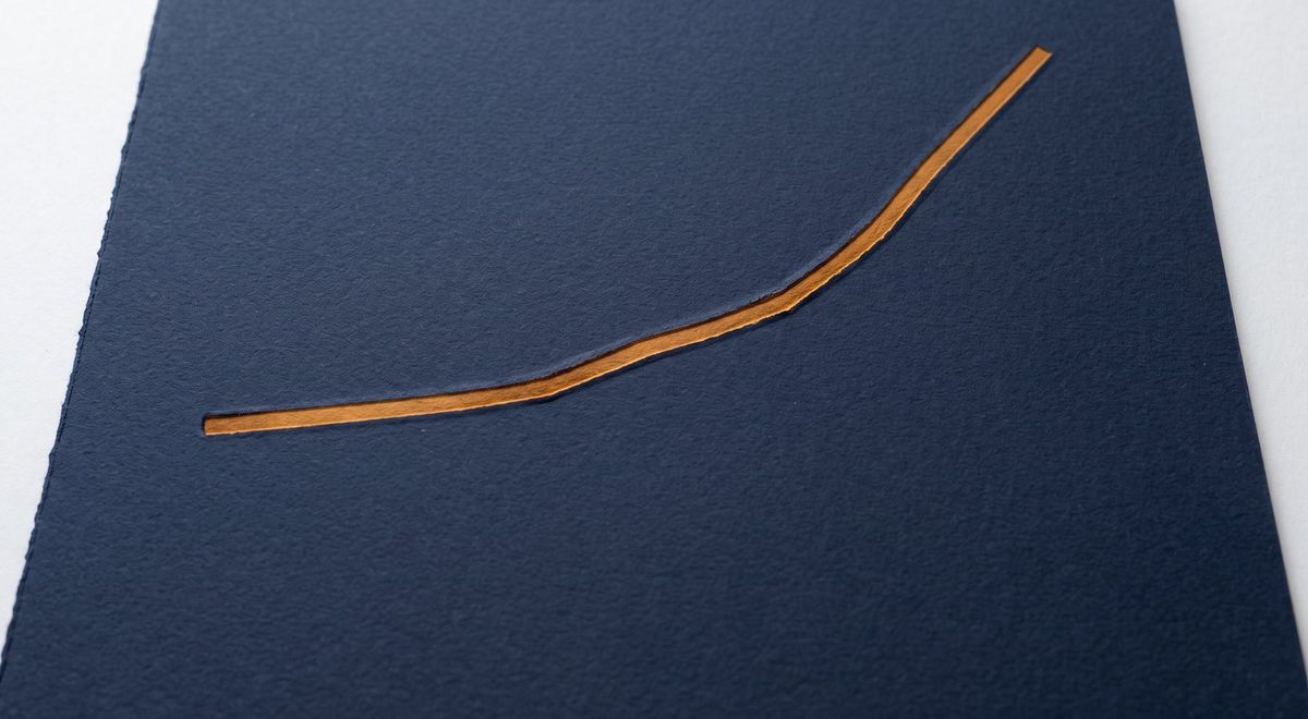 A single amber line rising steeply from lower left to upper right, pressed into navy paper with nothing else on the surface.
